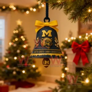 A blue and yellow Michigan Wolverines bell ornament with the letter M and wolverine logo hanging on a Christmas tree celebrating the 146th anniversary.
