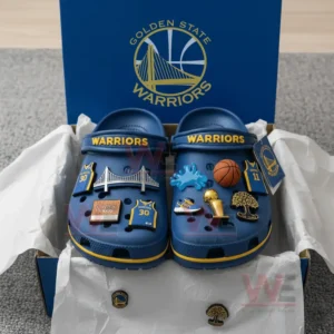 Alt text: Golden State Warriors Crocs placed in a box with various basketball-themed charms attached to them.