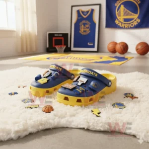 Blue and yellow Golden State Warriors clogs with basketball charms displayed on a white furry rug in a sports themed room!