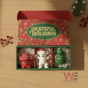 Open Grateful Holidays box containing red mushroom white bear and green turtle shaped candles arranged inside!