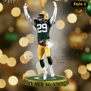 A celebratory ornament featuring Xavier McKinney of the Green Bay Packers with arms raised in celebration.