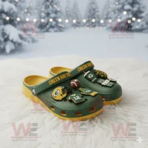 Green and yellow Green Bay Packers Crocs decorated with team charms placed on white fur in a winter scene!