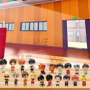 Rows of Haikyu character figures displayed on a wooden table inside a bright indoor gym!
