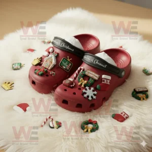 Red Hallmark Channel Crocs with festive Christmas themed charms placed on white fur rug surrounded by extra decorations!