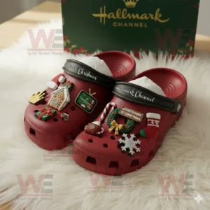 Red Crocs with Hallmark Channel logo and festive Christmas themed decorations displayed near branded green box!