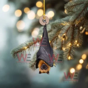 A bat ornament hanging upside down from a branch with glowing holiday lights in the background!