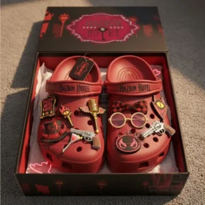 Red Hazbin Hotel themed clogs in an open box with assorted character inspired charms attached.