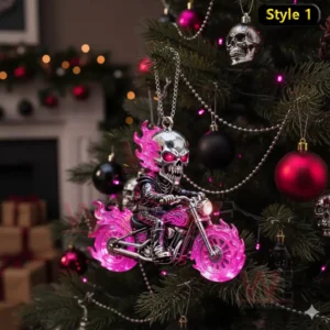 A flaming pink skull biker ornament hanging on a Christmas tree with red and black decorations.