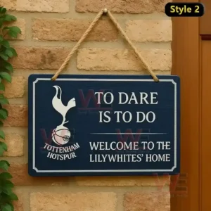 Home of Football Hanging Welcome Sign 7 A blue rectangular wooden sign with the Tottenham Hotspur logo and motto hanging on a brick wall.