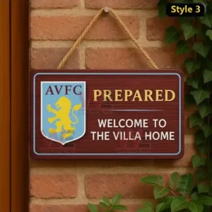 Home of Football Hanging Welcome Sign 8 A wooden sign with the Aston Villa logo and welcoming text displayed on a brick wall with green leaves.
