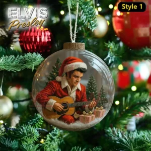 A Christmas ornament with Elvis Presley dressed as Santa playing guitar amidst a snowy Christmas backdrop with trees and gifts.