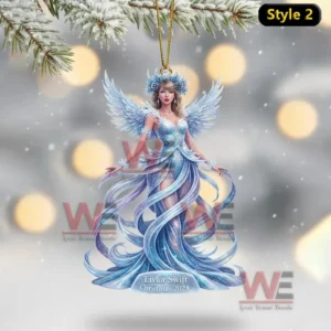 A blue winged figurine ornament hanging in a snowy winter scene.