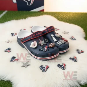 Houston Texans Crocs Crocband Clogs With Charms 6 Dark blue clogs with football themed charms displayed on a white rug with team decorations.