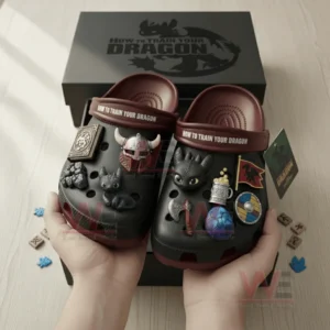 How to Train Your Dragon Crocs Crocband Clogs With Charms 8 Hands holding black and maroon dragon themed clogs near a themed box.
