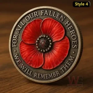 A bronze coin with a red poppy flower and engraved dedication to fallen heroes placed on a wooden surface.