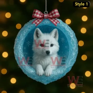 A white arctic fox inside a blue ice cave ornament with a red check bow and warm lights behind it!