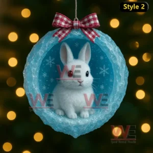 A polar bear cub inside a blue ice cave ornament with a red check bow and warm lights in the background!
