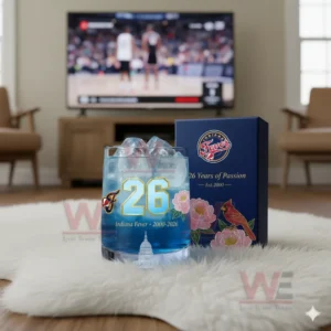 Indiana Fever whiskey glass with a blue drink and ice, set on the floor with a basketball game playing on the TV in the background.