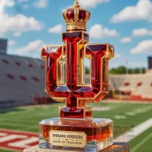 A red and gold Indiana University logo bottle sits on a ledge overlooking a football field inside a stadium.
