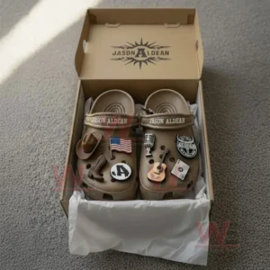 Jason Aldean Crocs Crocband Clogs With Charms 7 Brown clogs with country themed charms inside an open box.