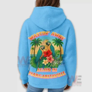 A rear view of a blue hoodie with a large colorful tropical bird design and surrounding island scenery!