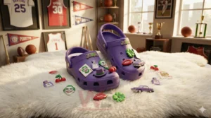 Alt text: Joker-themed crocs on a fluffy rug with scattered charms like Joker face, cherries, and lips.