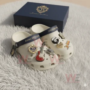 White Crocs decorated with Jonas Brothers inspired charms including red guitar, Lovebug