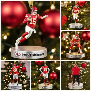A set of six football player ornaments posed on round bases in front of a Christmas tree!
