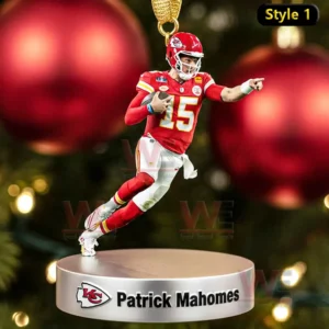 A football player ornament running with the ball on a round silver base in front of a Christmas tree!