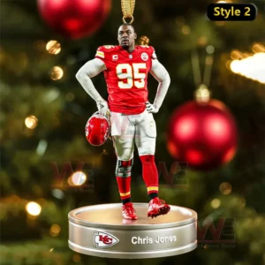 A football player ornament standing with a helmet on a round gold base in front of a Christmas tree!