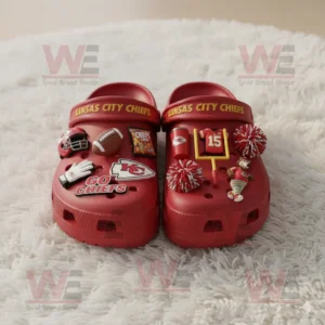 Red Crocs with Kansas City Chiefs logo and sports themed charms arranged on soft textured rug!