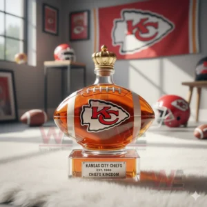A football shaped bottle with a crown cap resting on a white rug surrounded by Kansas City Chiefs themed decor!