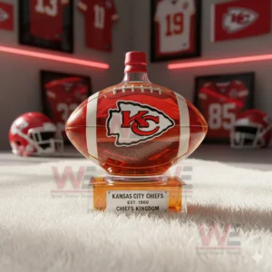 A clear football shaped bottle resting on a white rug in a room filled with Kansas City Chiefs decor!