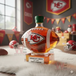 A football shaped bottle with a green cap resting on a white rug surrounded by Kansas City Chiefs themed decorations!