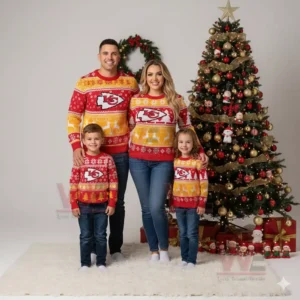 Family in matching red and yellow Chiefs Christmas sweaters standing beside a decorated Christmas tree with gifts and lights!