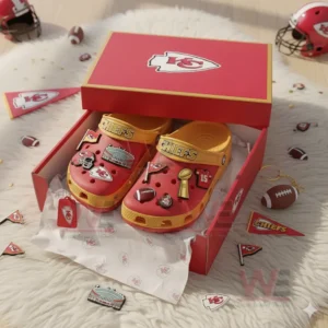 Kansas City Chiefs Crocs inside a red box with team logos, football items, and small accessories displayed around it.