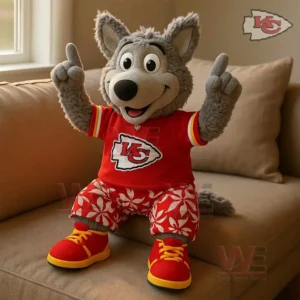 Kansas City Chiefs Wolf PLUSH PILLOW 3 Kansas City Chiefs plush wolf mascot wearing a red jersey sitting on a sofa near a window.