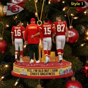 A Christmas ornament displaying four Kansas City Chiefs figures arranged on a themed stand with festive decorations behind them!