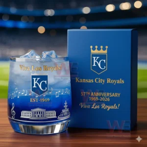 Kansas City Royals whiskey glass with ice and 57th anniversary box, displayed in front of a baseball stadium background.
