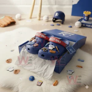 Blue Kansas City Royals Crocs in a box surrounded by baseball accessories and themed charms.