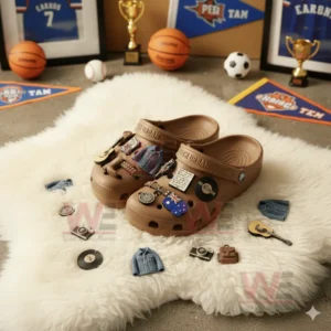 Keith Urban-themed Crocs with music and fashion-related charms displayed on a rug with sports memorabilia.