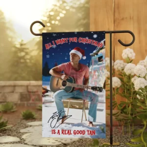 Kenny Chesney Christmas Garden Flag 6 Alt text: A Christmas flag with Kenny Chesney in a pink shirt and Santa hat, holding a guitar, with a warm, snowy background.