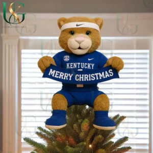 Kentucky Wildcats mascot tree topper wearing blue uniform and holding Merry Christmas banner on decorated tree!
