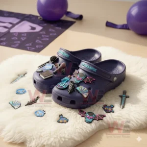 Kpop Demon Hunters-themed Crocs with skulls, bats, and mystical charms displayed on a rug with purple accents.
