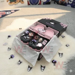 Pink and black Kuromi themed clogs in an open box with assorted charms scattered nearby.!