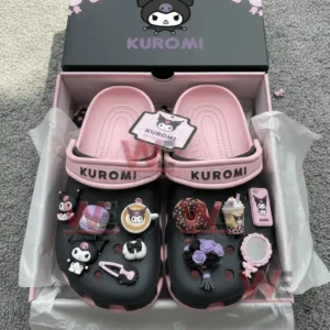 A boxed pair of pink and black clogs covered with various Kuromi themed charms.!