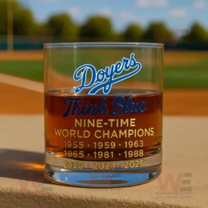 Clear whiskey glass with Doyers Think Blue Nine Time World Champions text and gold championship years printed on the front!```