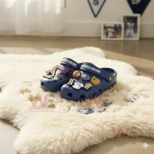 Blue baseball themed clogs on a fluffy white rug in a bright room.