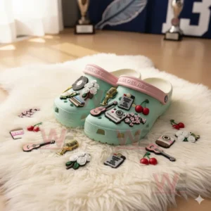 Lana Del Rey Crocs Crocband Clogs With Charms 6 Pastel green clogs decorated with colorful themed charms placed on a white furry rug in a sunlit room!