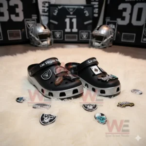 Las Vegas Raiders-themed Crocs displayed in a room surrounded by helmets, framed jerseys, and team patches.